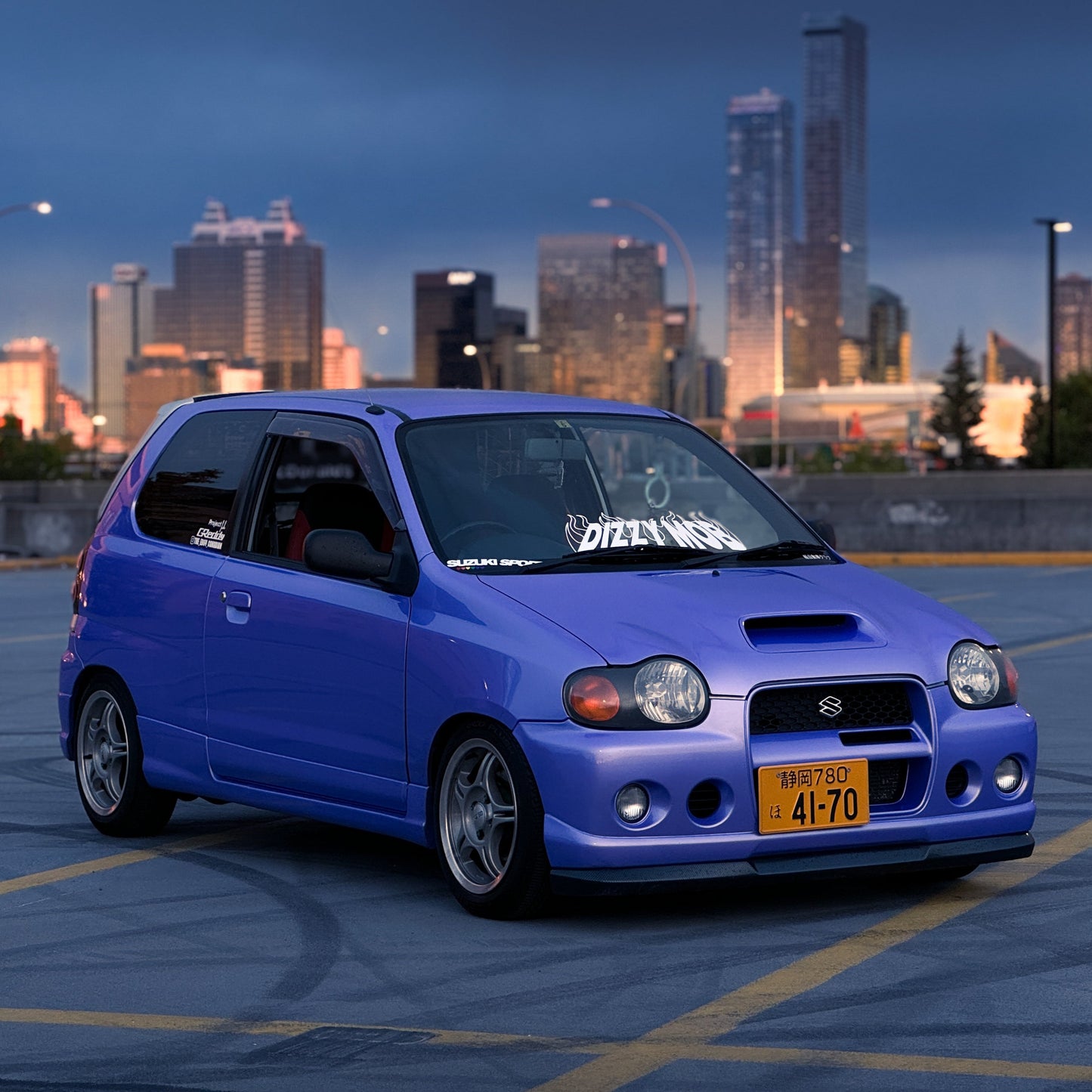Custom Japanese license plate front of city skyline