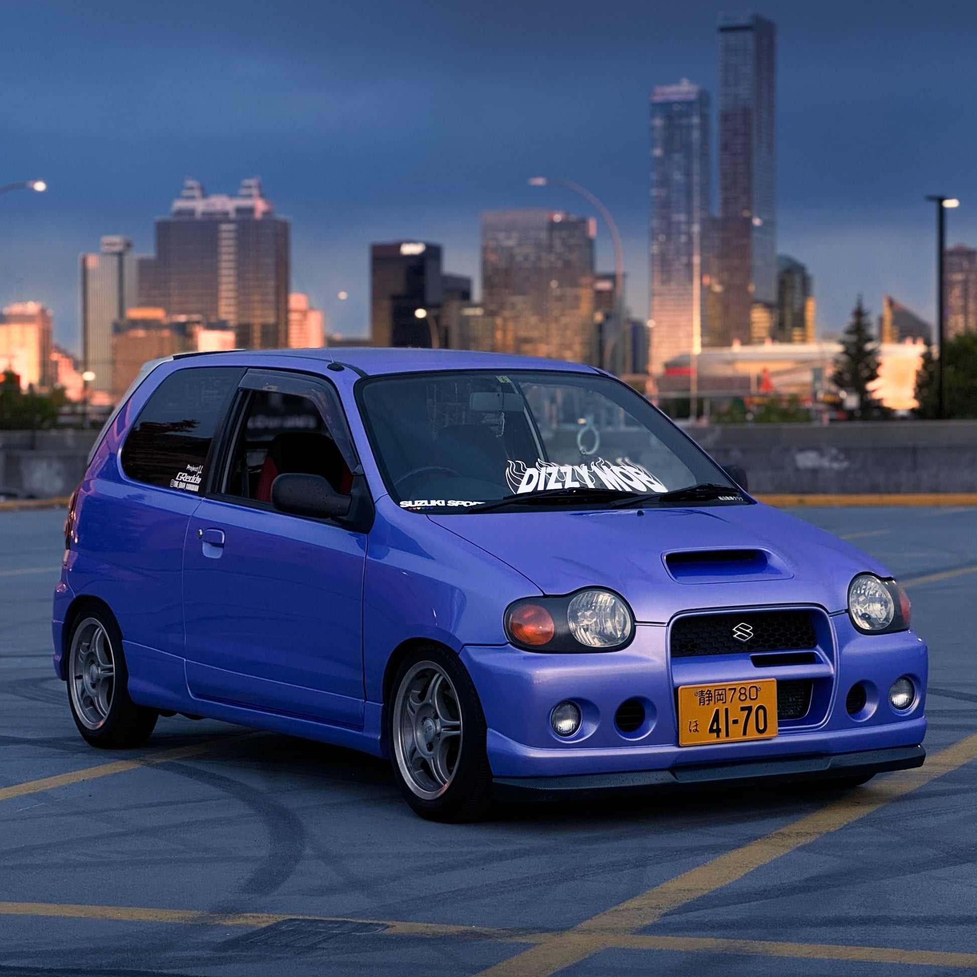 Custom Japanese license plate front of city skyline